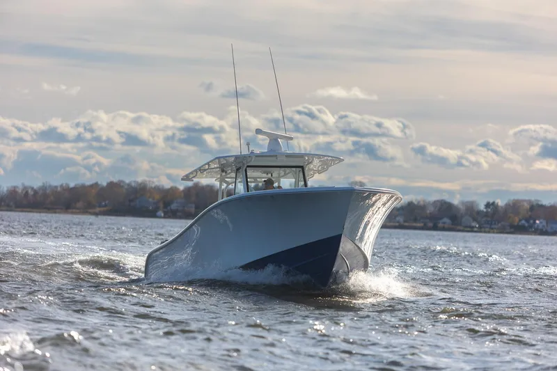 Slide: The Image of 2018 Yellowfin 39 Offshore boat cruising on open water under cloudy sky. - 61