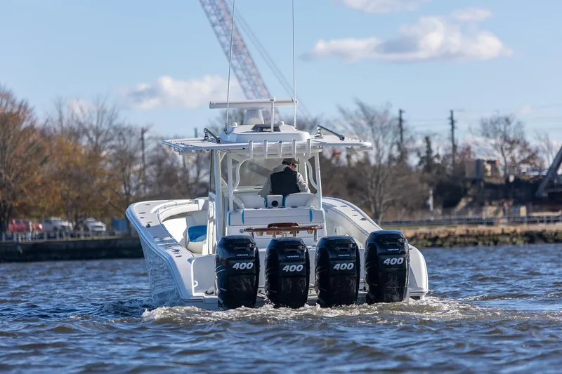 Slide: The Image of 2018 Yellowfin 39 Offshore boat with four powerful engines cruising on water. - 17