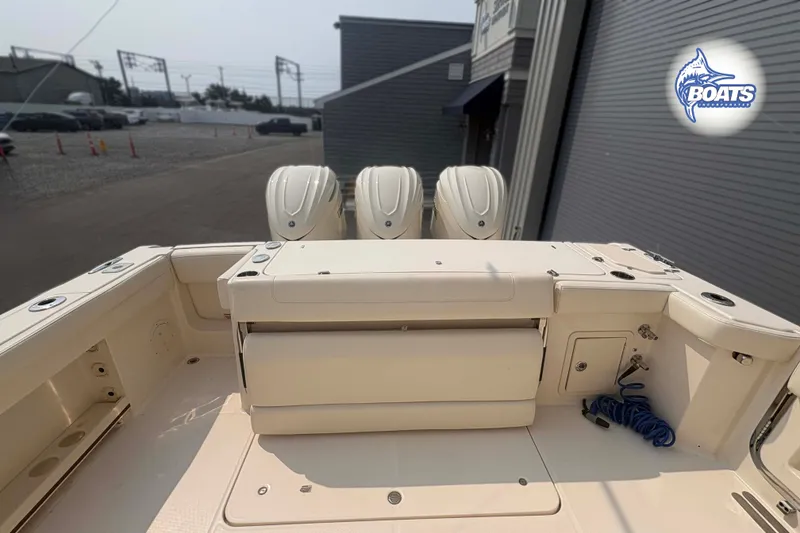 Slide: The Image of 2024 Grady-White Canyon 336 boat with triple engines, docked outdoors. - 13