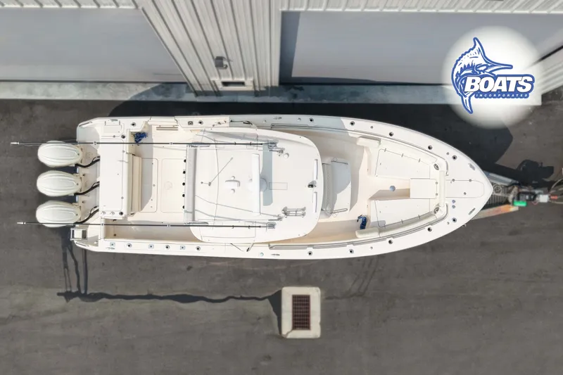 Slide: The Image of Overhead view of 2024 Grady-White Canyon 336 boat docked, featuring triple engines. - 15
