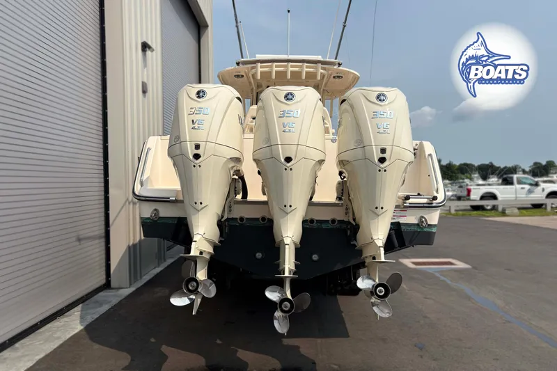 Slide: The Image of 2024 Grady-White Canyon 336 boat with triple Yamaha 350 V6 engines, docked outdoors. - 14