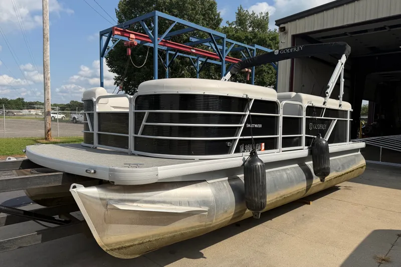 Slide: The Image of 2023 Godfrey Sweetwater 2086 CX pontoon boat on trailer, parked outdoors. - 6
