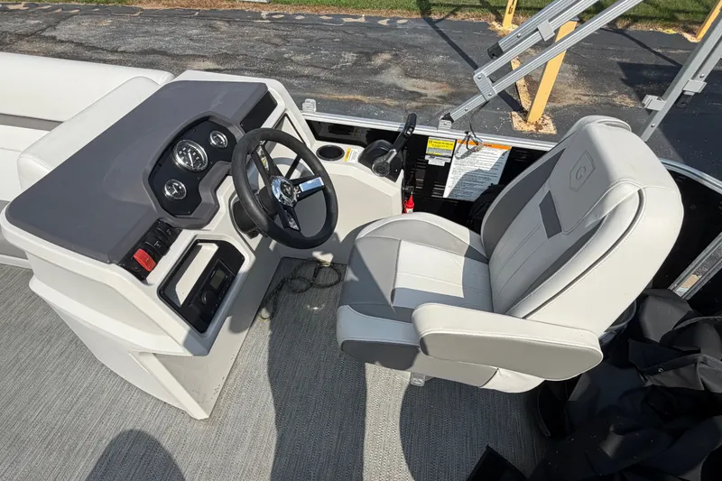 Slide: The Image of 2023 Godfrey Sweetwater 2086 CX boat interior with steering wheel and captain's chair. - 11
