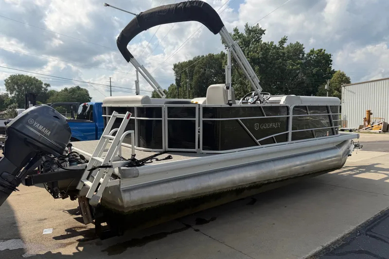 Slide: The Image of 2023 Godfrey Sweetwater 2086 CX pontoon boat with Yamaha motor, parked outdoors. - 3