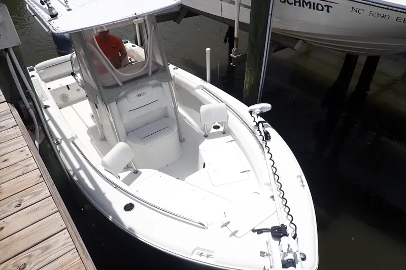 Slide: The Image of 2017 Sea Hunt Ultra 211 boat docked, featuring a sleek white design and spacious seating. - 3