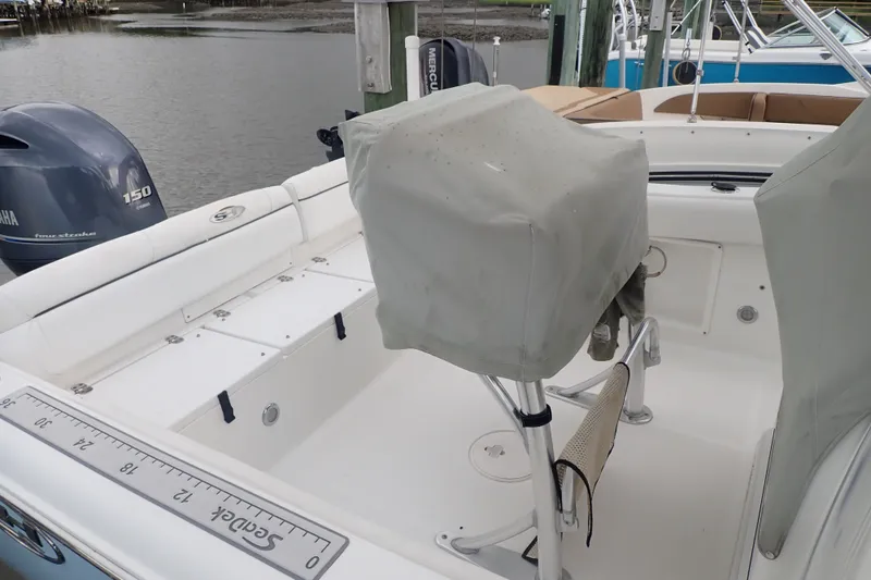 Slide: The Image of 2017 Sea Hunt Ultra 211 boat interior with covered seats and Yamaha 150 engine. - 41