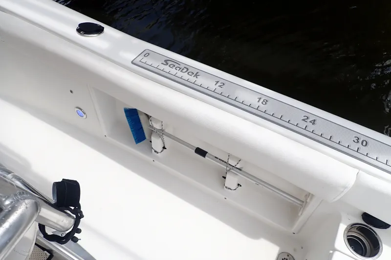 Slide: The Image of 2017 Sea Hunt Ultra 211 boat interior with SeaDek ruler and storage compartment. - 17