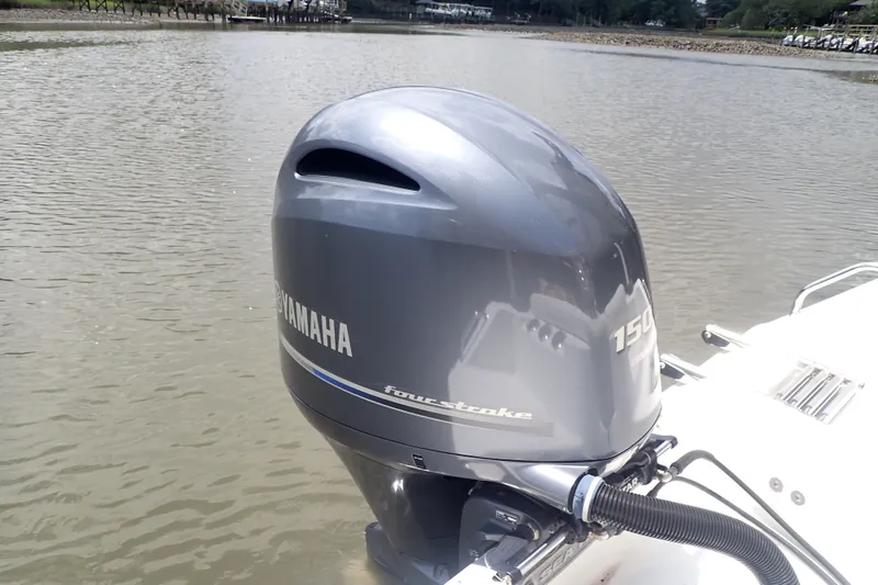 Slide: The Image of 2017 Sea Hunt Ultra 211 with Yamaha 150 outboard motor on calm water. - 42