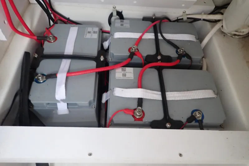 Slide: The Image of Battery compartment of 2017 Sea Hunt Ultra 211 boat with connected cables. - 38