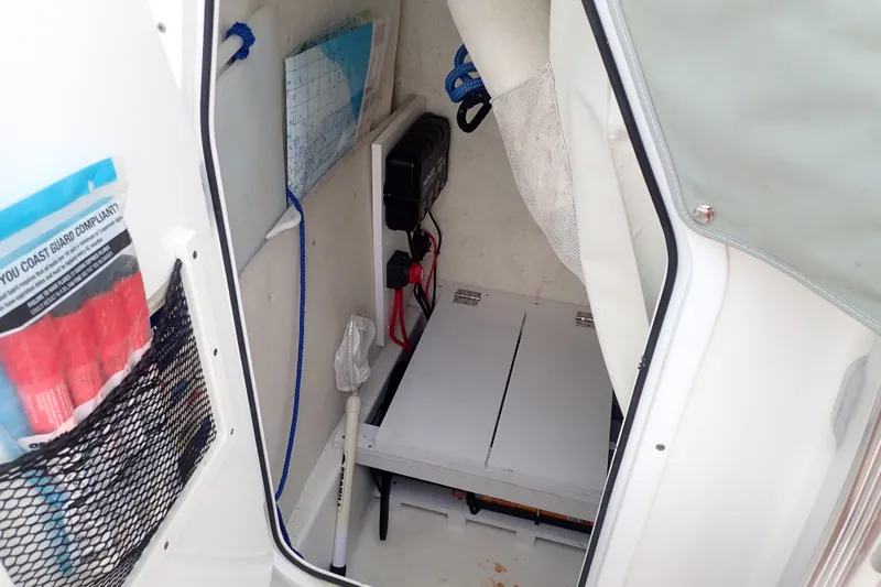 Slide: The Image of Interior storage of 2017 Sea Hunt Ultra 211 boat with safety equipment and maps. - 37