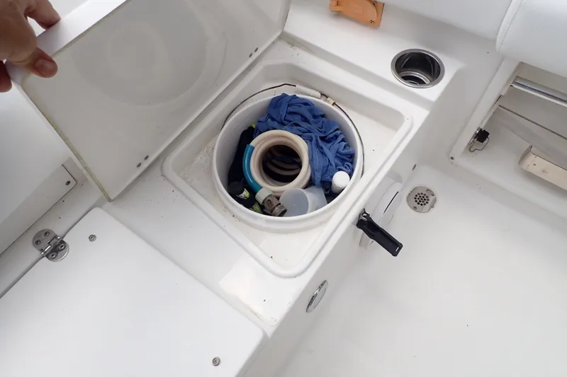 Slide: The Image of Storage compartment on a 2017 Sea Hunt Ultra 211 boat with various items inside. - 34