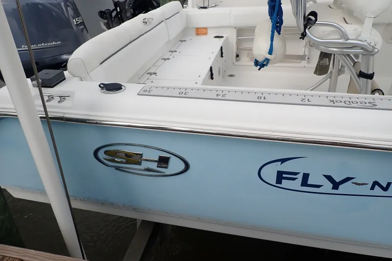 Slide: The Image of 2017 Sea Hunt Ultra 211 boat with white seating and blue exterior detailing. - 35