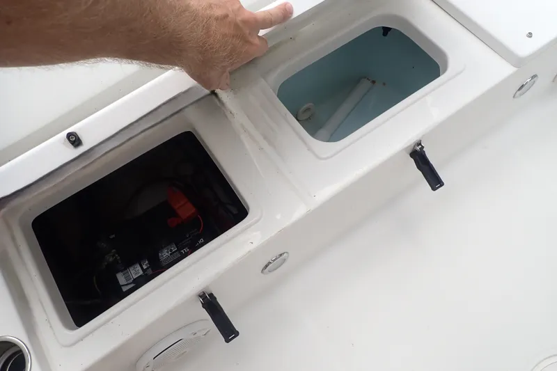 Slide: The Image of 2017 Sea Hunt Ultra 211 boat compartments with battery and storage. - 33