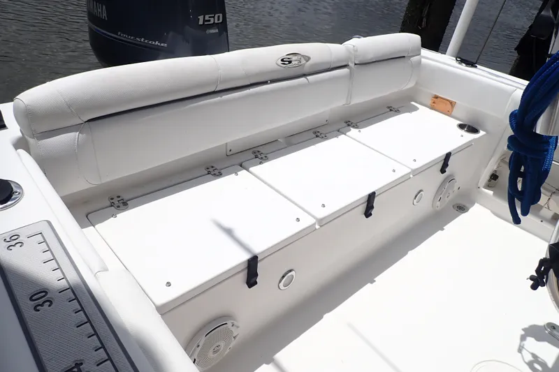 Slide: The Image of 2017 Sea Hunt Ultra 211 boat interior with cushioned seating and storage compartments. - 40