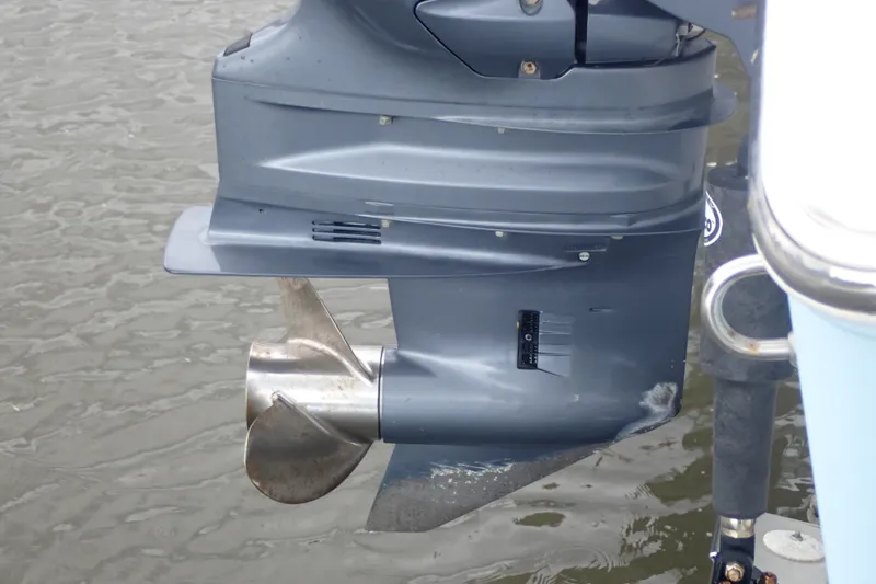 Slide: The Image of Outboard motor of a 2017 Sea Hunt Ultra 211 boat on water. - 47
