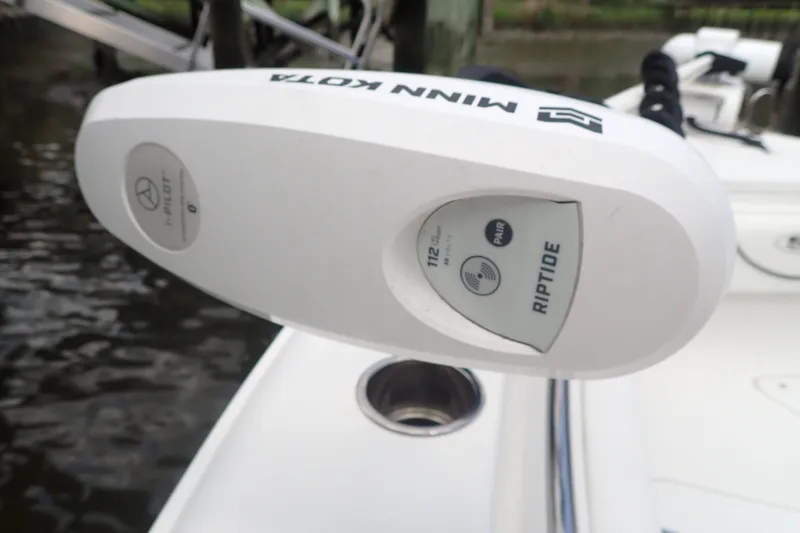 Slide: The Image of Minn Kota Riptide motor on 2017 Sea Hunt Ultra 211 boat, docked by water. - 50