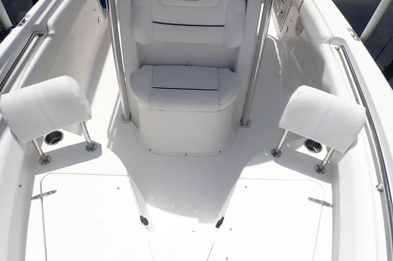 Slide: The Image of 2017 Sea Hunt Ultra 211 boat interior with white seating and stainless steel fixtures. - 12