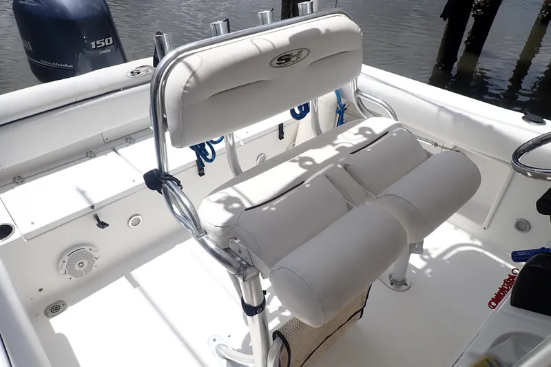 Slide: The Image of 2017 Sea Hunt Ultra 211 boat interior with seating and Yamaha 150 engine. - 10