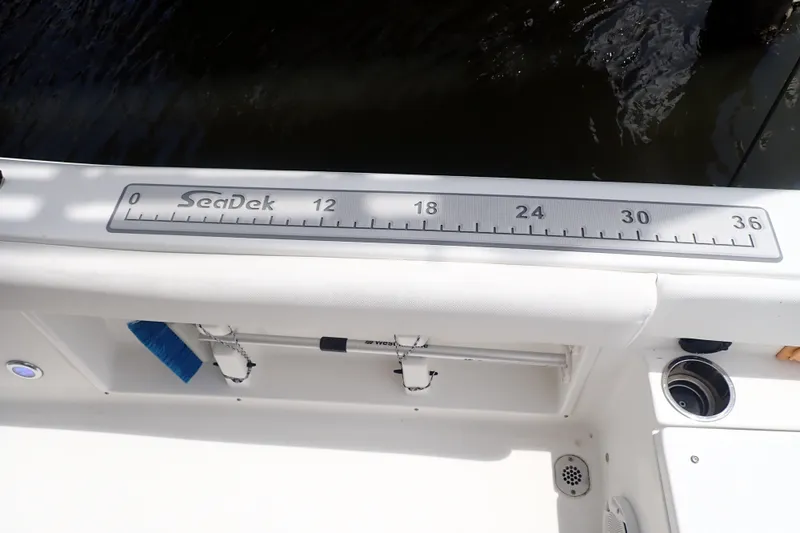 Slide: The Image of Sea Hunt Ultra 211 boat with SeaDek ruler, 2017 model, featuring a clean white deck. - 16