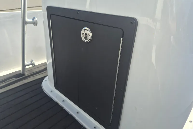 Slide: The Image of Key West 1720 Center Console boat storage compartment, 1992 model, with secure latch. - 9