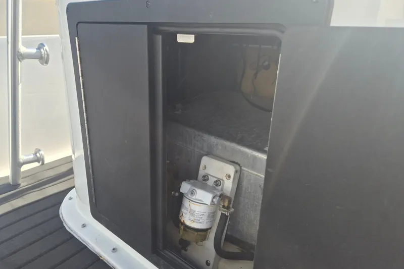 Slide: The Image of Open compartment on a 1992 Key West 1720 Center Console boat, revealing internal components. - 10