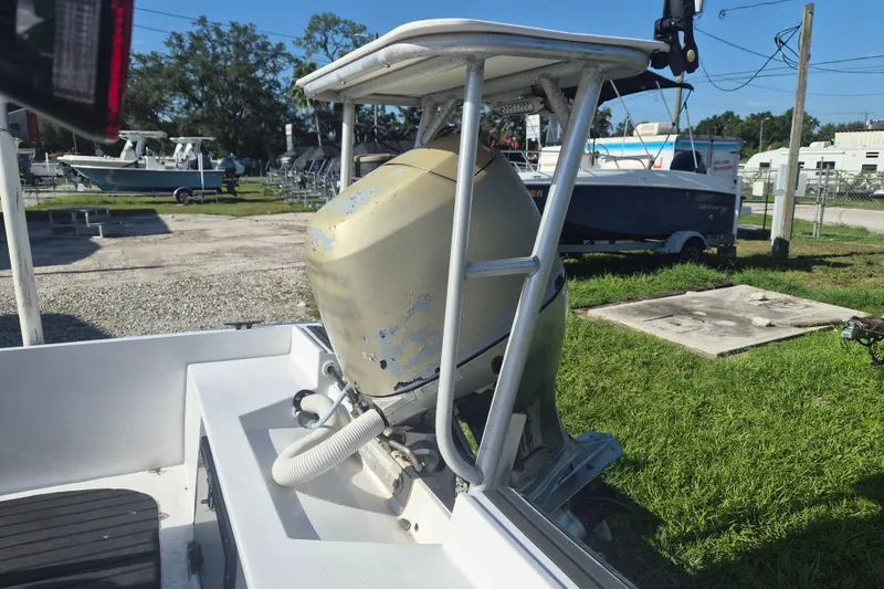 Slide: The Image of 1992 Key West 1720 Center Console boat with an outboard motor in a marina setting. - 4