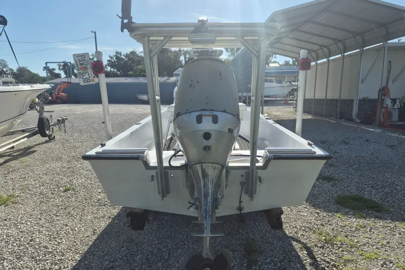 Slide: The Image of 1992 Key West 1720 Center Console boat with outboard motor, parked on gravel. - 3