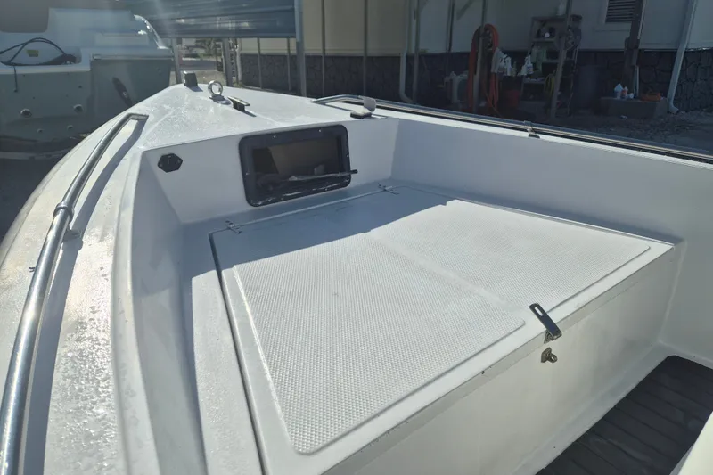 Slide: The Image of 1992 Key West 1720 Center Console boat interior with storage compartment and clean deck. - 14