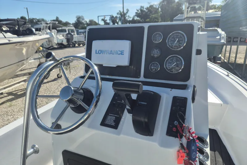Slide: The Image of 1992 Key West 1720 Center Console boat dashboard with steering wheel and gauges. - 8