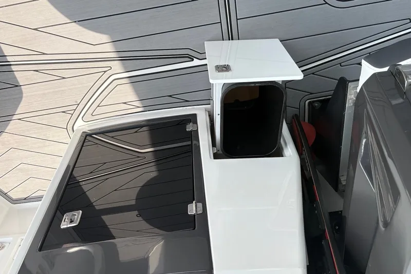 Slide: The Image of 2023 Monterey 298SS Super Sport boat deck with storage compartments and sleek design. - 27