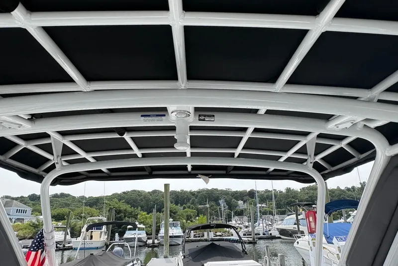 Slide: The Image of 2023 Monterey 298SS Super Sport boat canopy with marina background. - 20