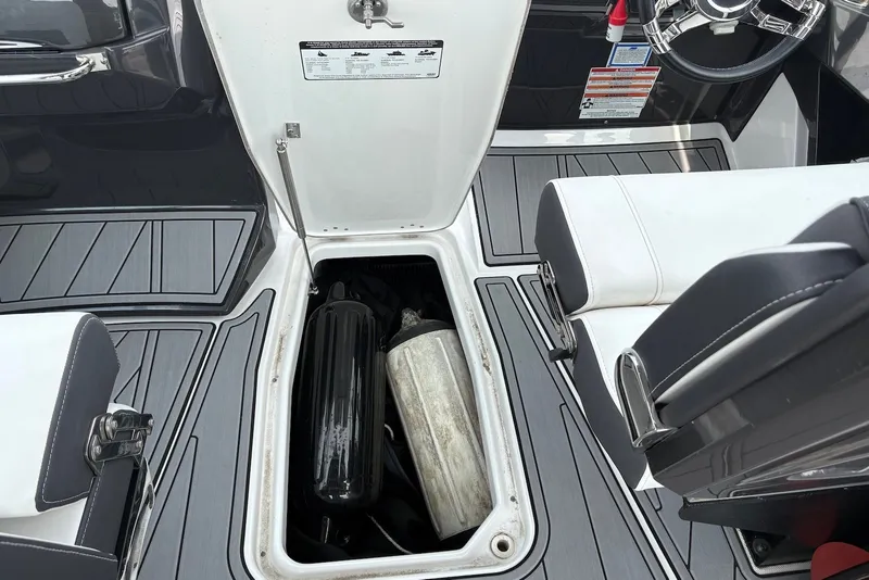 Slide: The Image of 2023 Monterey 298SS Super Sport boat interior with open storage compartment and seating. - 26
