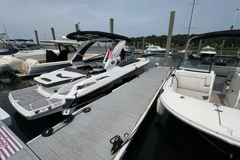 The Image of 2023 Monterey 298SS Super Sport boat docked at a marina, showcasing sleek design and luxury features. - 0