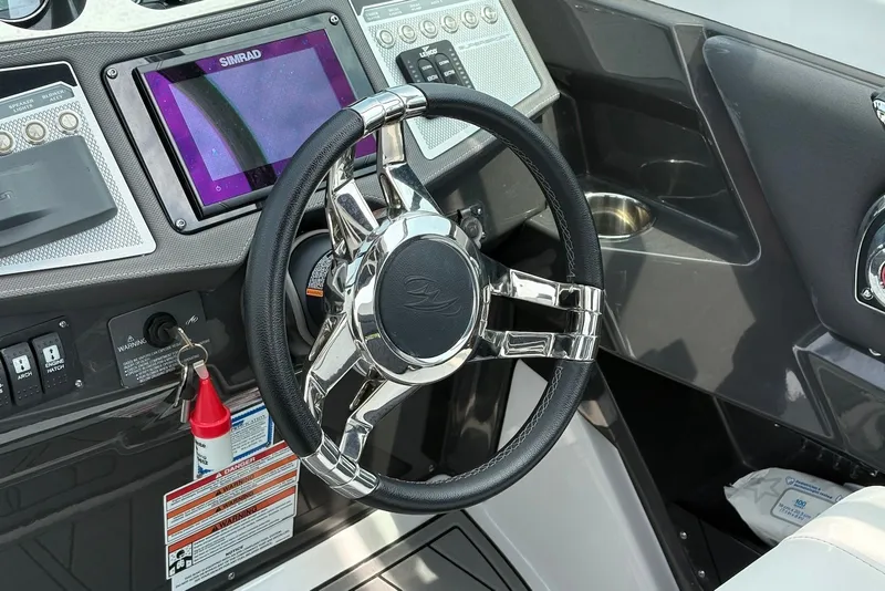 Slide: The Image of 2023 Monterey 298SS Super Sport boat dashboard with steering wheel and navigation system. - 15
