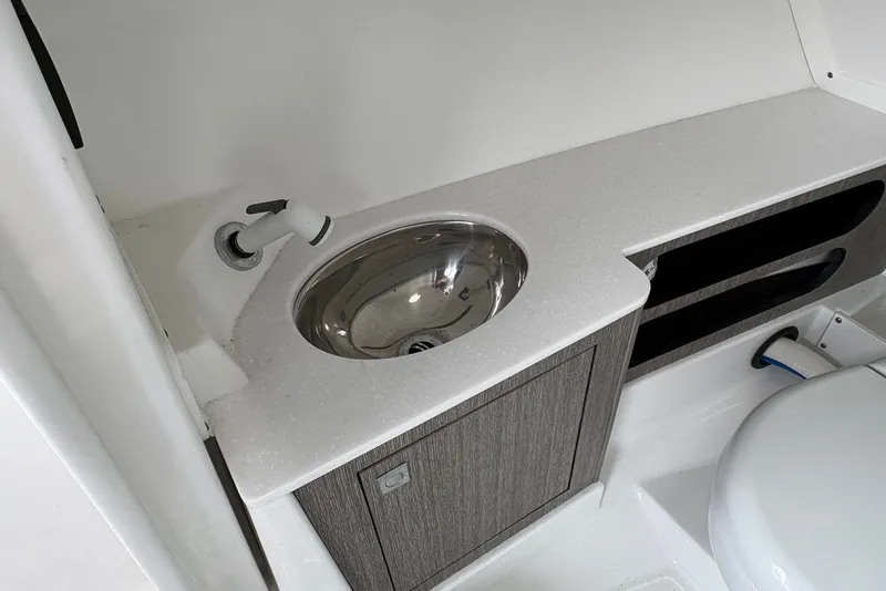 Slide: The Image of 2023 Monterey 298SS Super Sport boat bathroom with sink and storage cabinet. - 24