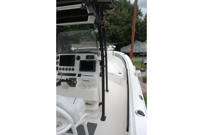 Slide: The Image of 2014 Scarab 255 boat cockpit with navigation equipment and seating. - 14