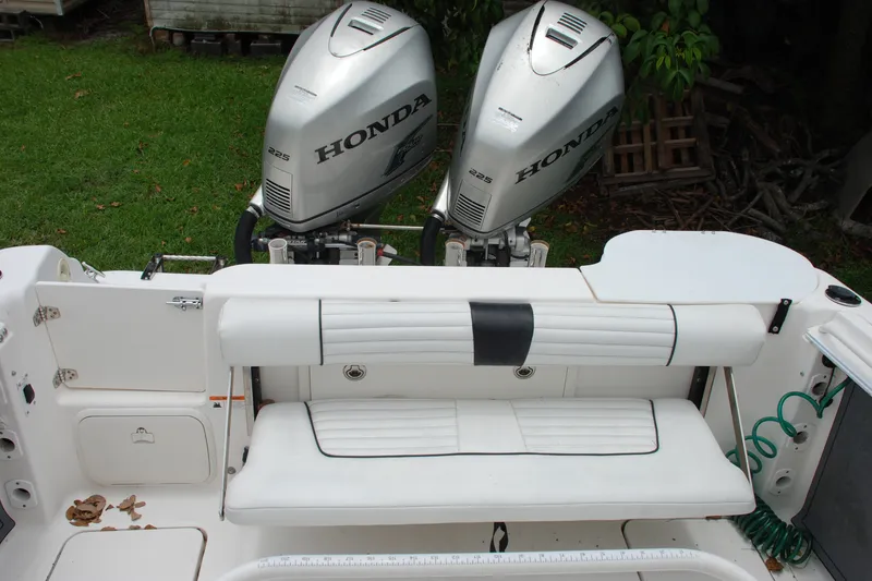 Slide: The Image of 2014 Scarab 255 boat with dual Honda 225 engines and white seating. - 18