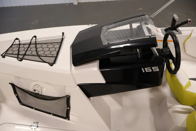 Slide: The Image of 2017 Scarab 165 G boat dashboard with steering wheel and storage nets. - 16