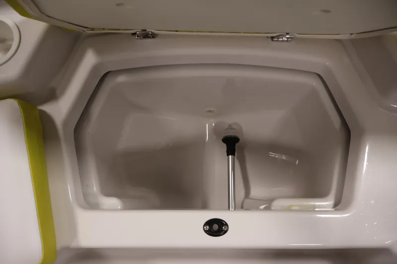 Slide: The Image of Storage compartment of a 2017 Scarab 165 G boat, featuring a clean interior. - 12