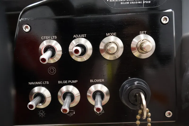 Slide: The Image of Control panel of a 2017 Scarab 165 G boat with switches and key ignition. - 20