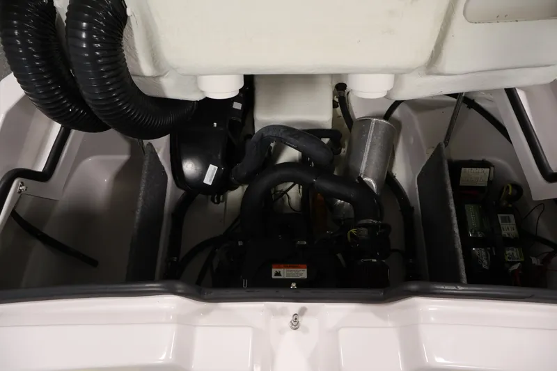 Slide: The Image of Engine compartment of a 2017 Scarab 165 G boat, showing mechanical components and wiring. - 24