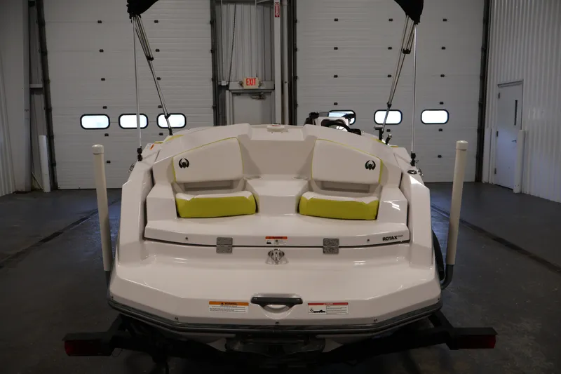 Slide: The Image of 2017 Scarab 165 G boat in a garage, rear view with lime green seating. - 6