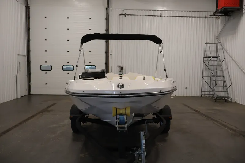 Slide: The Image of 2017 Scarab 165 G boat in a garage, front view with trailer. - 2