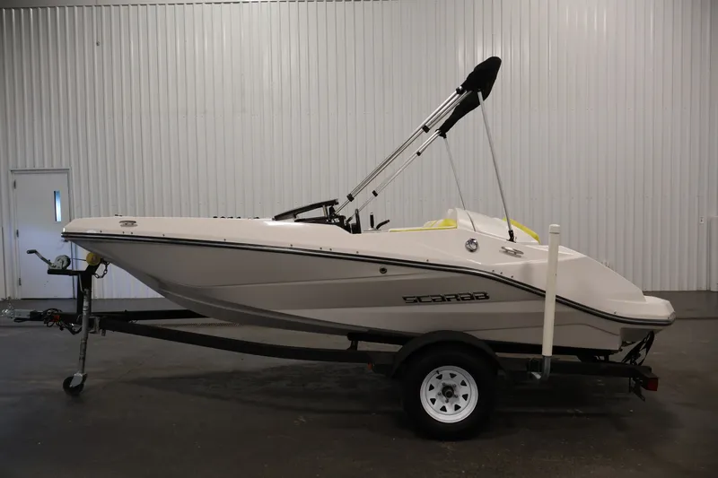Slide: The Image of 2017 Scarab 165 G boat on trailer in indoor storage facility. - 8