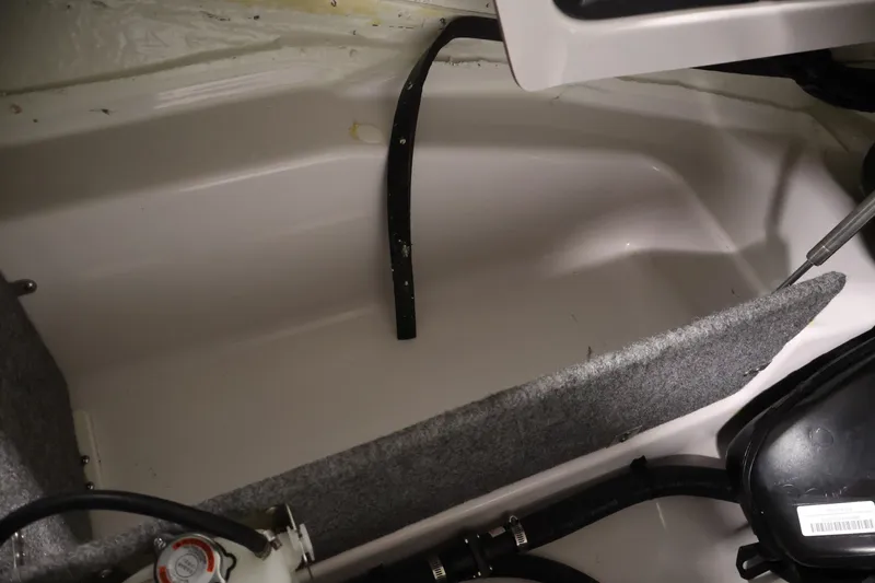 Slide: The Image of Interior view of a 2017 Scarab 165 G boat compartment with visible components. - 27