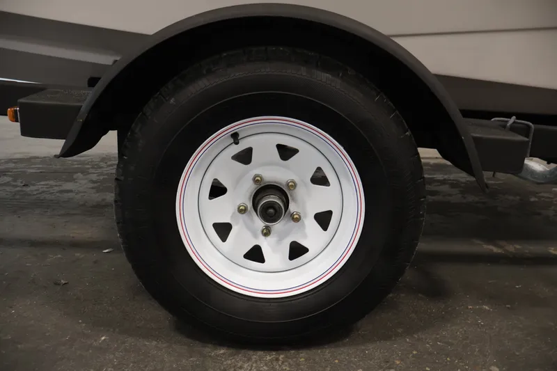 Slide: The Image of Trailer wheel of a 2017 Scarab 165 G with white rim and black tire. - 32