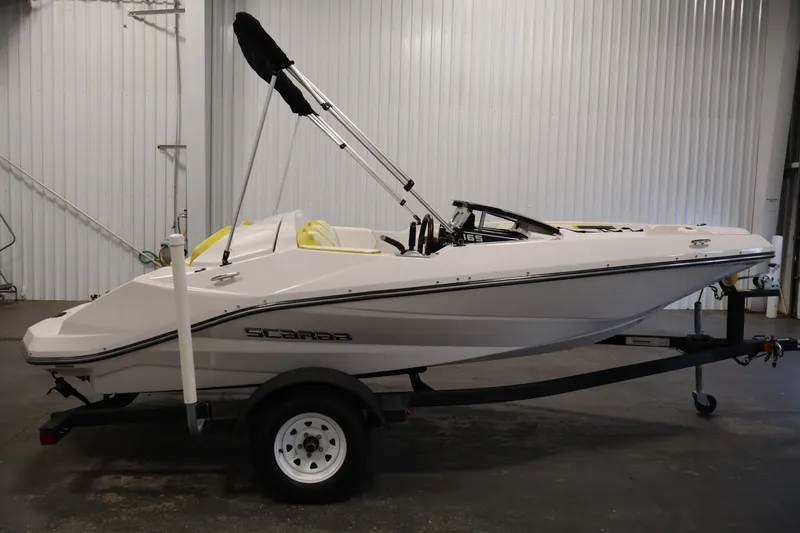 Slide: The Image of 2017 Scarab 165 G boat on trailer in indoor storage facility. - 4