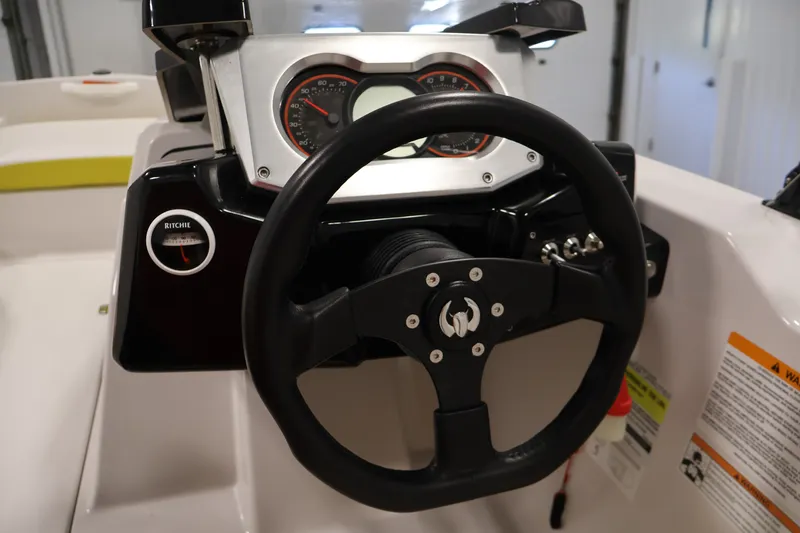 Slide: The Image of Steering wheel and dashboard of 2017 Scarab 165 G boat. - 17