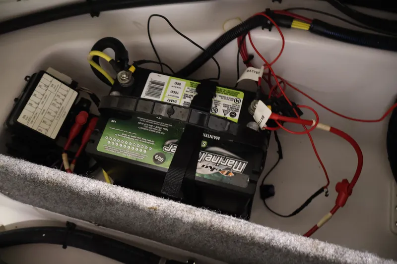 Slide: The Image of Battery compartment of a 2017 Scarab 165 G boat with wiring connections. - 26