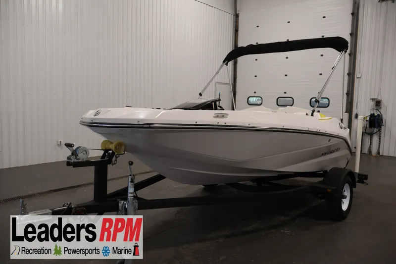 The Image of 2017 Scarab 165 G boat on trailer in indoor showroom setting. - 1